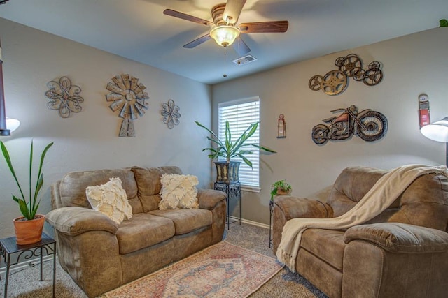 living area featuring ceiling fan, carpet flooring, visible vents, and baseboards