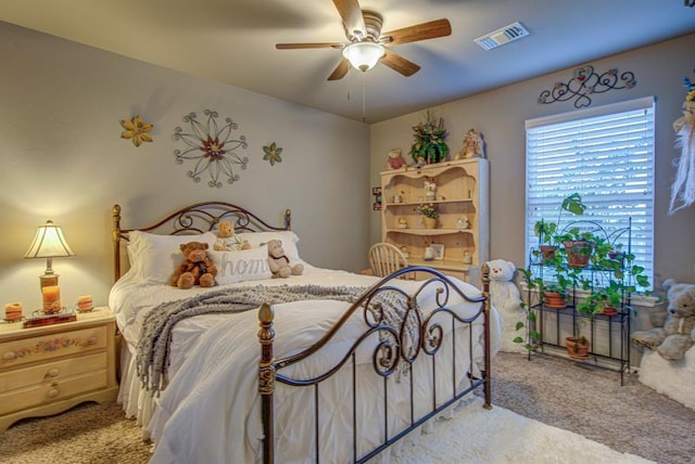 carpeted bedroom featuring ceiling fan and visible vents