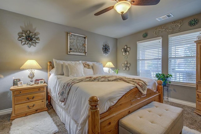 bedroom featuring carpet floors, visible vents, baseboards, and a ceiling fan