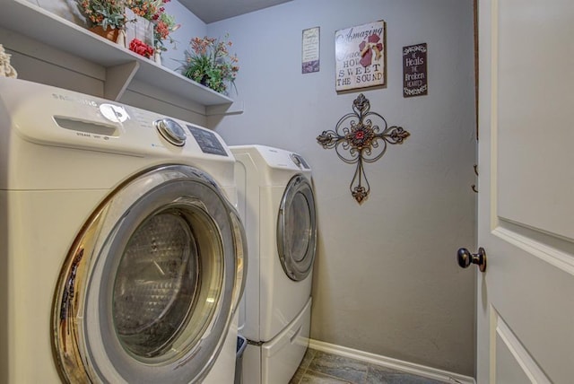 laundry area featuring laundry area, baseboards, and separate washer and dryer