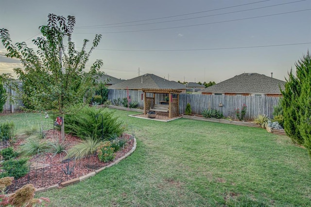 view of yard featuring a fenced backyard and a vegetable garden