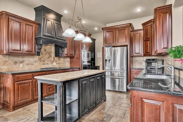 kitchen featuring tasteful backsplash, dark stone counters, stainless steel appliances, premium range hood, and a sink