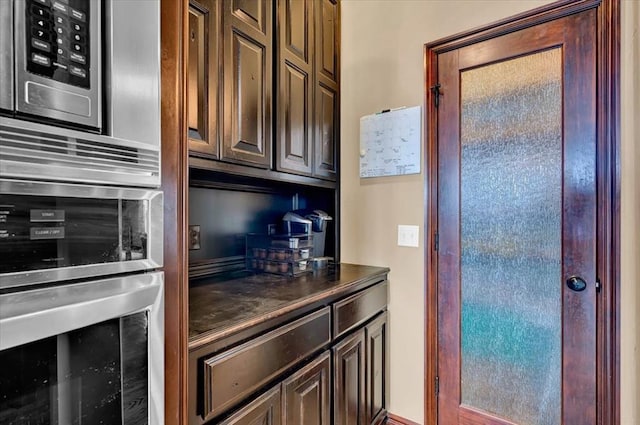 kitchen with dark countertops and appliances with stainless steel finishes