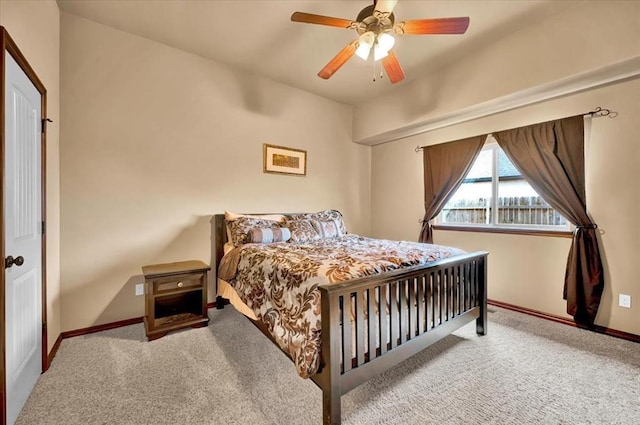 carpeted bedroom featuring ceiling fan and baseboards