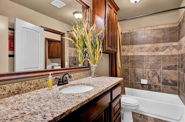 full bathroom featuring toilet, shower / bathtub combination with curtain, visible vents, and vanity