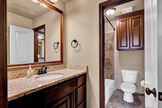 full bathroom featuring tile patterned flooring, toilet, visible vents, vanity, and washtub / shower combination