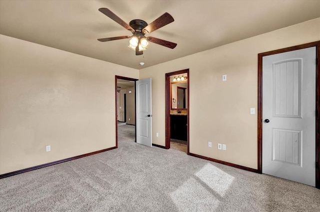 unfurnished bedroom with carpet floors, connected bathroom, a ceiling fan, and baseboards