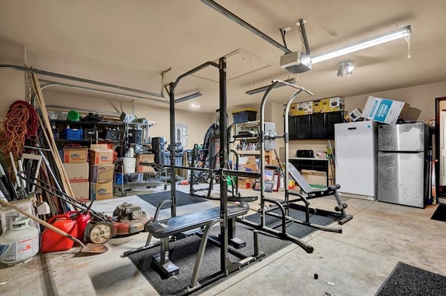 garage featuring refrigerator, a garage door opener, and freestanding refrigerator