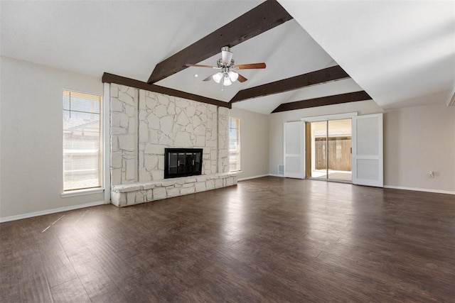 unfurnished living room featuring lofted ceiling with beams, baseboards, wood finished floors, and a fireplace