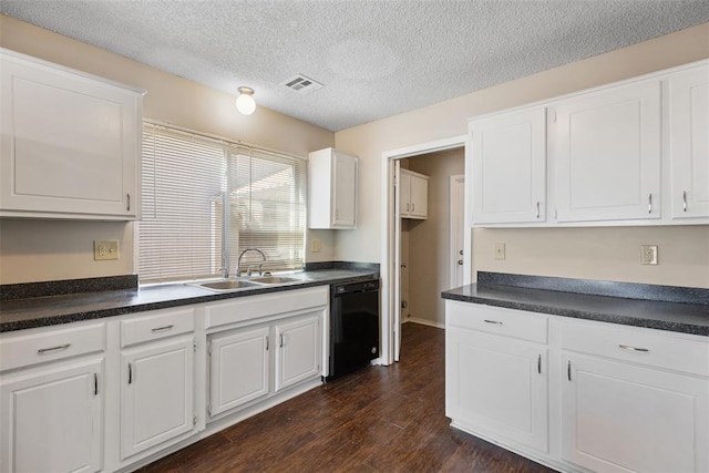 kitchen with dark wood-style floors, visible vents, a sink, black dishwasher, and dark countertops