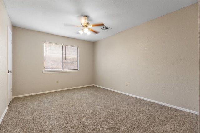 empty room featuring baseboards, visible vents, a ceiling fan, and carpet