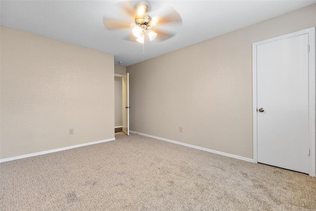 unfurnished room with ceiling fan, baseboards, and carpet floors