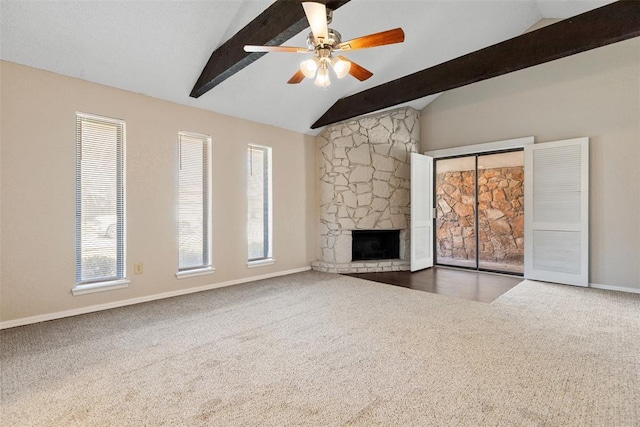 unfurnished living room featuring a fireplace, vaulted ceiling with beams, carpet, and ceiling fan