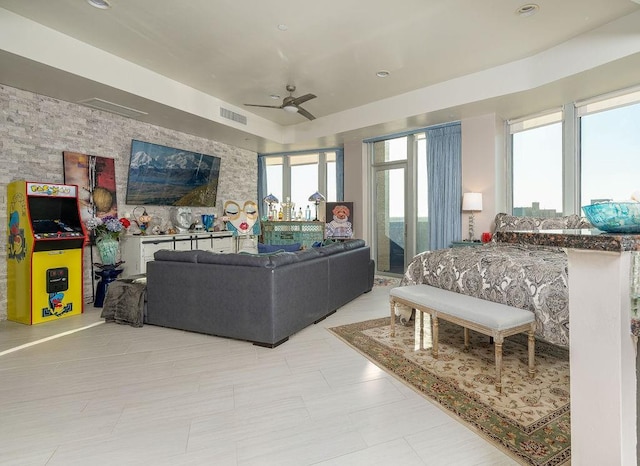 living room featuring visible vents and ceiling fan