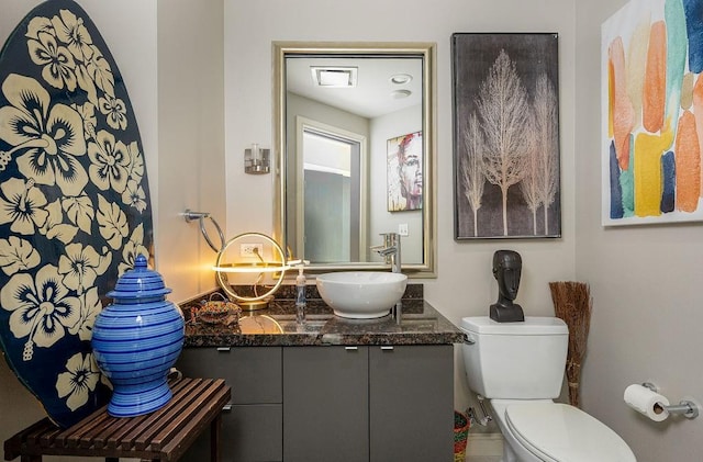 bathroom featuring toilet and vanity