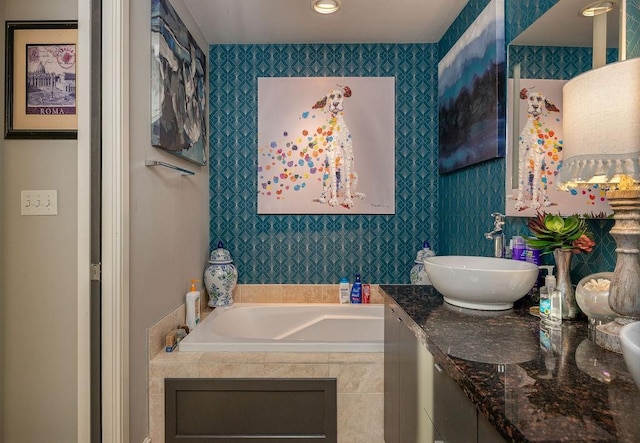 bathroom with vanity and a garden tub