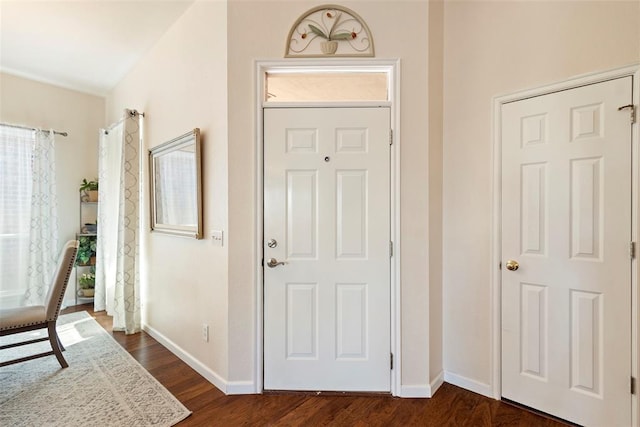 foyer entrance featuring dark wood-style flooring and baseboards