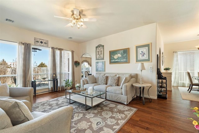 living room featuring a ceiling fan, baseboards, visible vents, and hardwood / wood-style floors