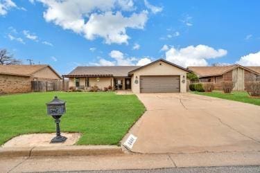 ranch-style home featuring a garage, driveway, and a front yard