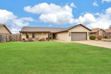 ranch-style house featuring driveway, a garage, fence, and a front lawn