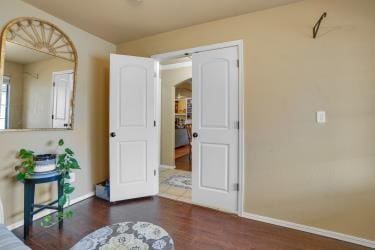 interior space with baseboards and wood finished floors