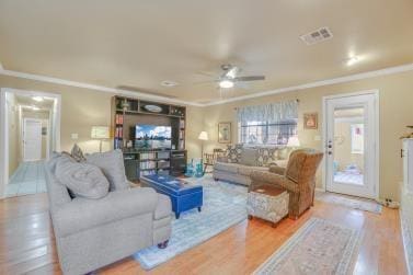 living room featuring a ceiling fan, wood finished floors, visible vents, and crown molding