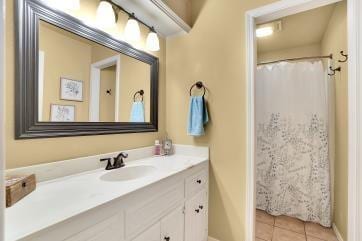 full bath featuring vanity, baseboards, and tile patterned floors