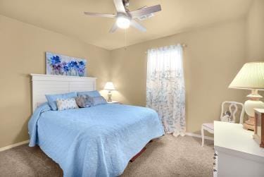 bedroom with carpet flooring, a ceiling fan, and baseboards