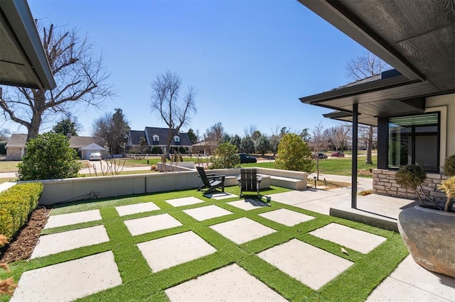 view of yard featuring fence and a patio