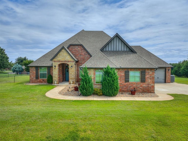 craftsman-style home with roof with shingles, driveway, and a front lawn