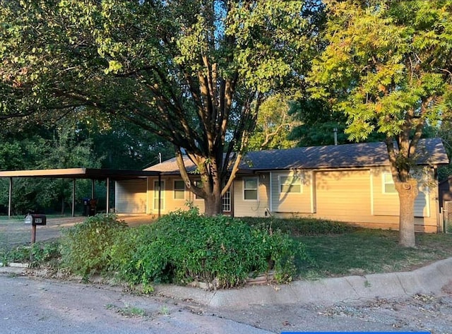 ranch-style house featuring a carport