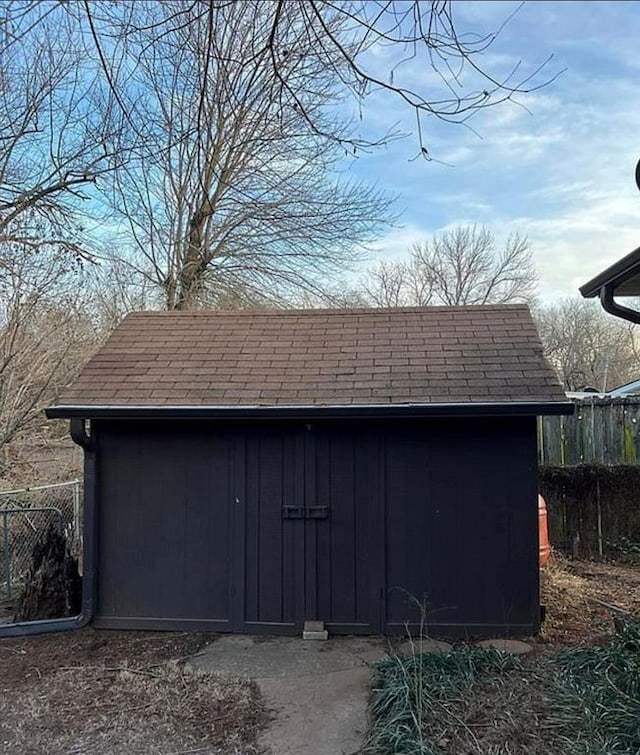 view of shed featuring fence