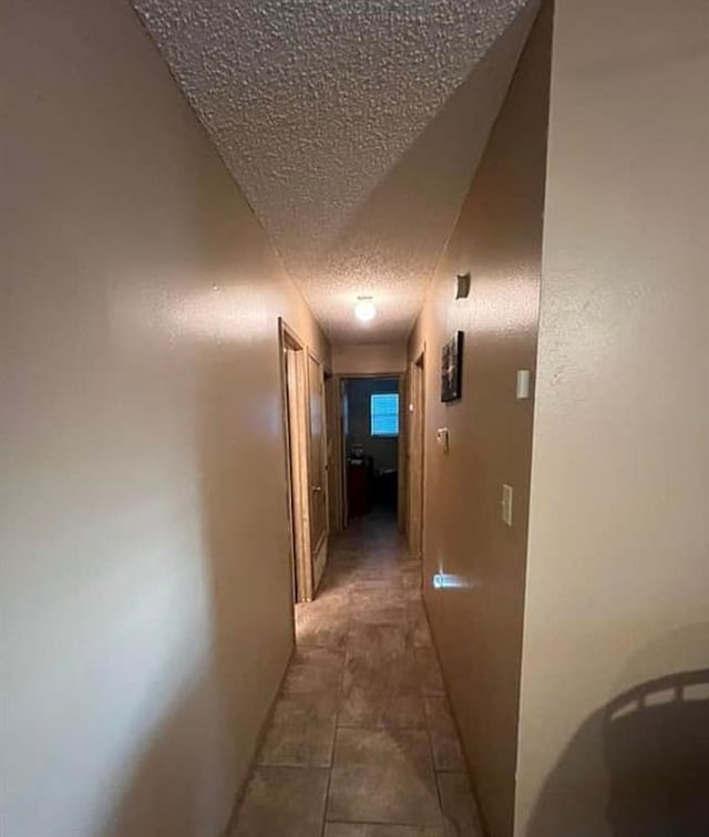 hallway with a textured ceiling