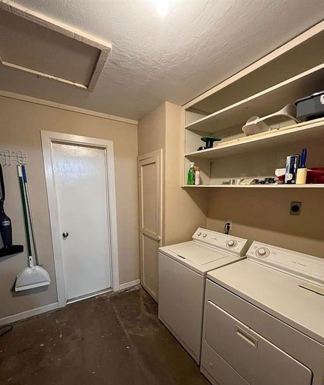 clothes washing area featuring washer and dryer, a textured ceiling, attic access, and laundry area