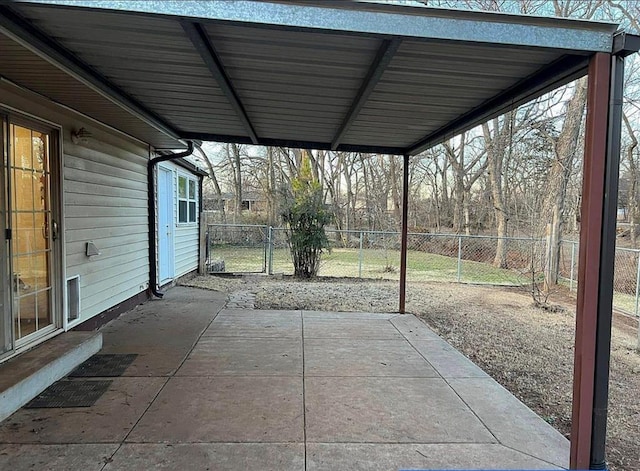 view of patio with a carport and fence