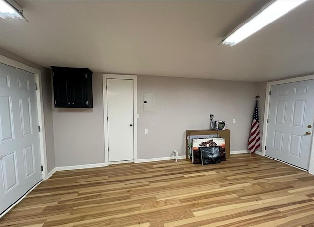 interior space featuring light wood finished floors and baseboards