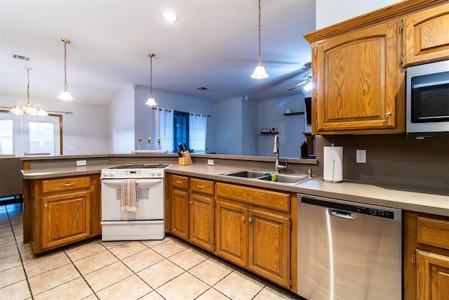 kitchen featuring brown cabinetry, visible vents, stainless steel appliances, and a sink