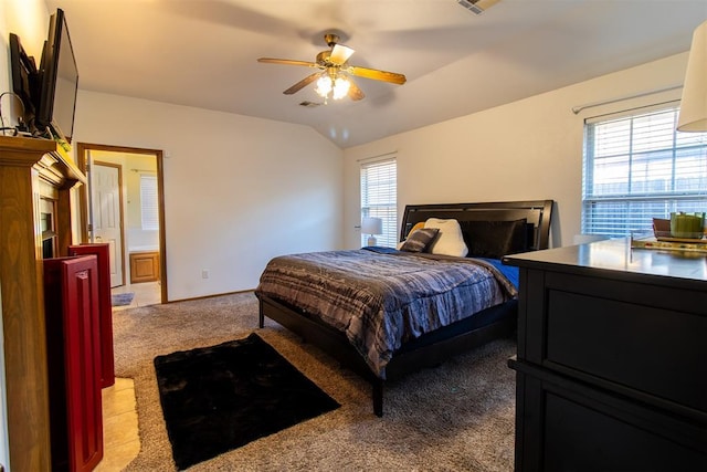 carpeted bedroom featuring lofted ceiling, visible vents, and ceiling fan