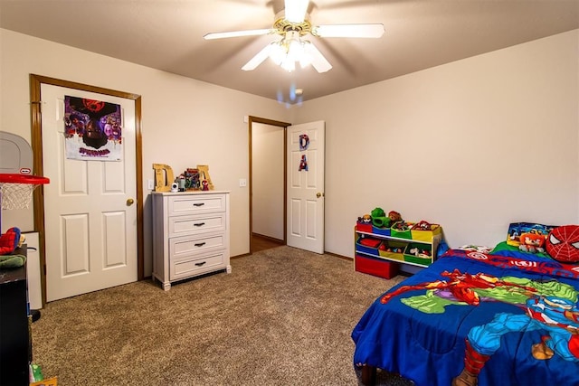 bedroom with ceiling fan and dark carpet