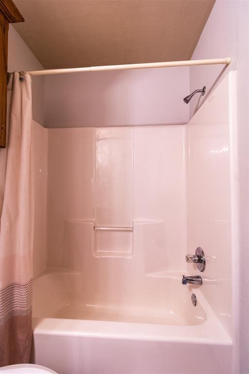 bathroom featuring shower / bathtub combination with curtain