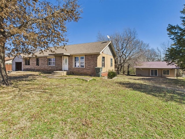 ranch-style home featuring brick siding, crawl space, and a front lawn