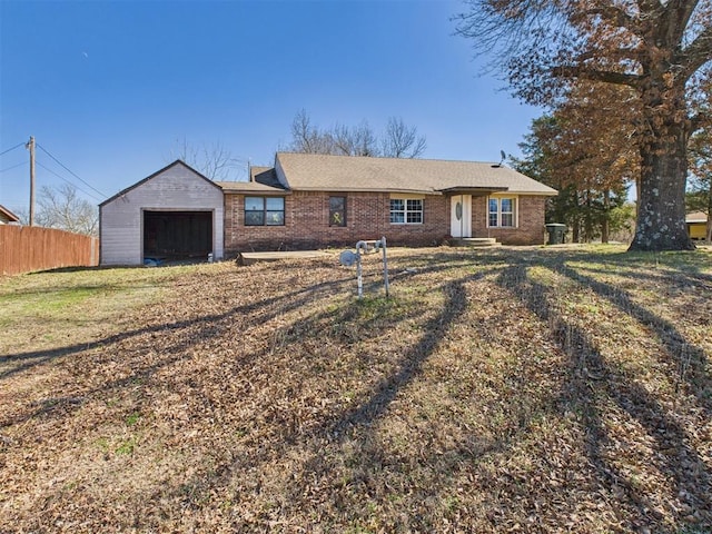 ranch-style home featuring a garage, brick siding, and fence