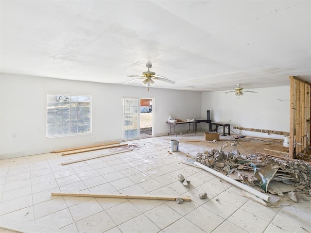 interior space featuring baseboards and ceiling fan