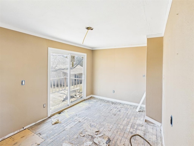 unfurnished dining area with crown molding, baseboards, and wood-type flooring