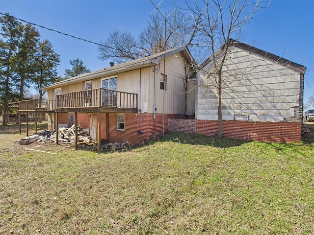 view of side of property with a lawn and a deck