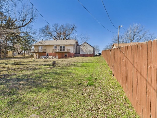 view of yard featuring a wooden deck and fence