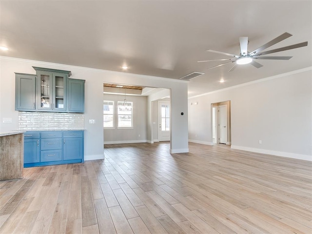 unfurnished living room with visible vents, baseboards, ceiling fan, crown molding, and light wood-style floors