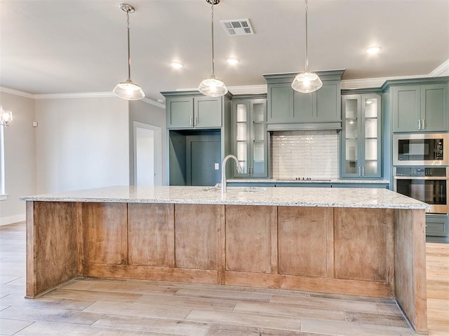 kitchen featuring light stone countertops, visible vents, appliances with stainless steel finishes, and tasteful backsplash