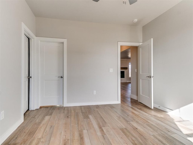 unfurnished bedroom featuring baseboards and light wood finished floors