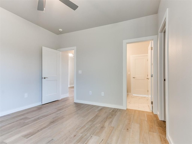 unfurnished bedroom with light wood finished floors, a ceiling fan, and baseboards